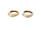 A pair of gold huggie hoop earrings with a textured silver-colored center channel and a small clear gemstone on each earring, shown against a plain white background.