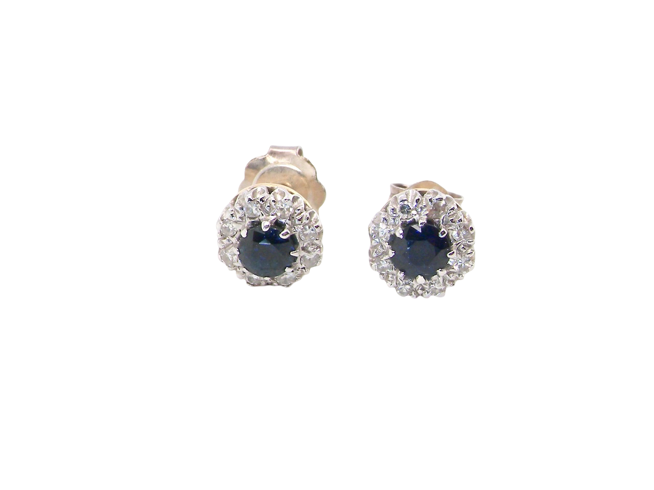 A pair of stud cluster earrings. Each earring is set with a dark blue sapphire centre .

Measures 4mm, surrounded by an outer halo of eight 1.3mm diamonds 