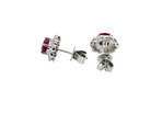 side A pair of white gold earrings, each set with an oval ruby 6x4.9mm (est 0.60 carats) complimented by an outer halo of ten 1.5mm diamonds