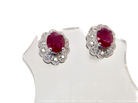A pair of white gold earrings, each set with an oval ruby 6x4.9mm (est 0.60 carats) complimented by an outer halo of ten  diamonds