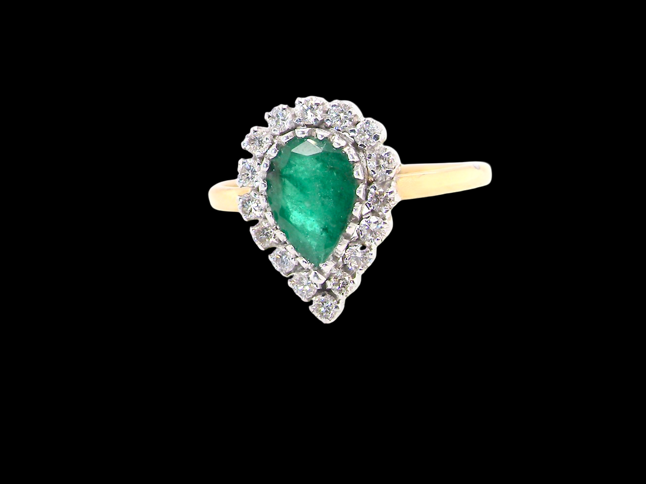 A pear shaped Emerald and Diamond cluster ring