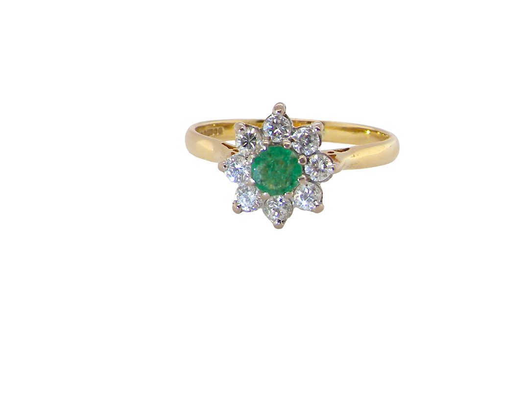 A pretty 18 carat gold cluster ring. The centre stone is a round emerald 4mm diameter (0.25 carats) mid green colour.
