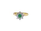 An emerald and diamond cluster ring