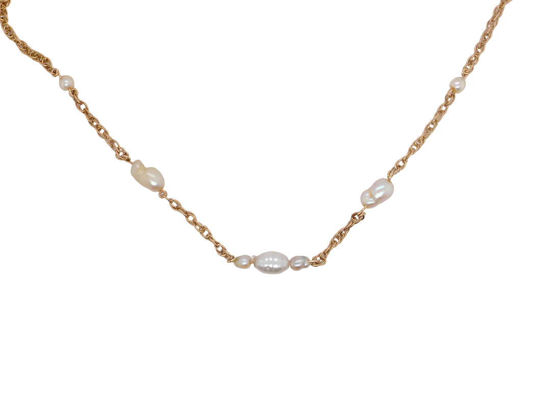 A delicate gold chain necklace featuring irregular white baroque pearls spaced along the chain, displayed on a clean white background.