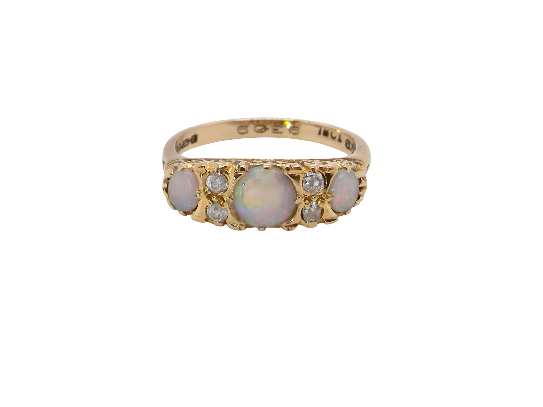 A pretty Victorian style ring. 18 carat gold. There are three&nbsp; opals, centre 6mm, each end 4x3mm. Good colour play