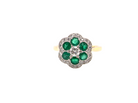 A pretty cluster ring. Features emeralds and diamonds. Centre stone a brilliant cut white diamond, measures 4mm (0.25 carats).&nbsp;
