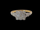 A pretty diamond cluster ring from the early part of the 20th century. A square head that has within it small white diamonds, measures 8x8mm, fancy shoulders 