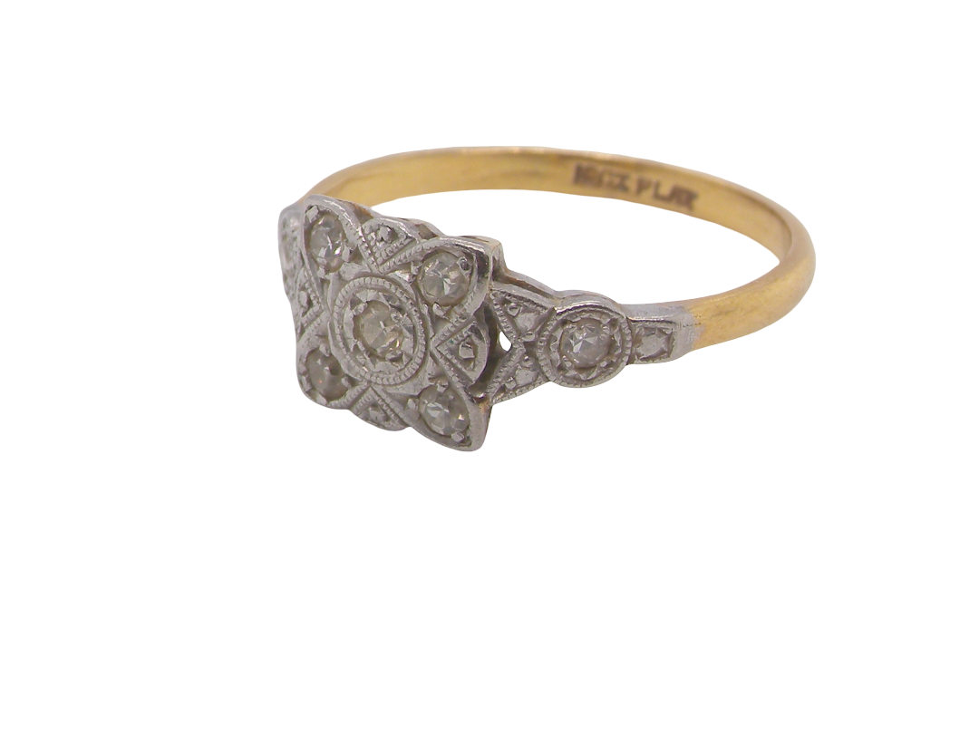 A pretty diamond cluster ring from the early part of the 20th century. A square head that has within it small white diamonds, measures 8x8mm, fancy shoulders also set with tiny diamonds.side