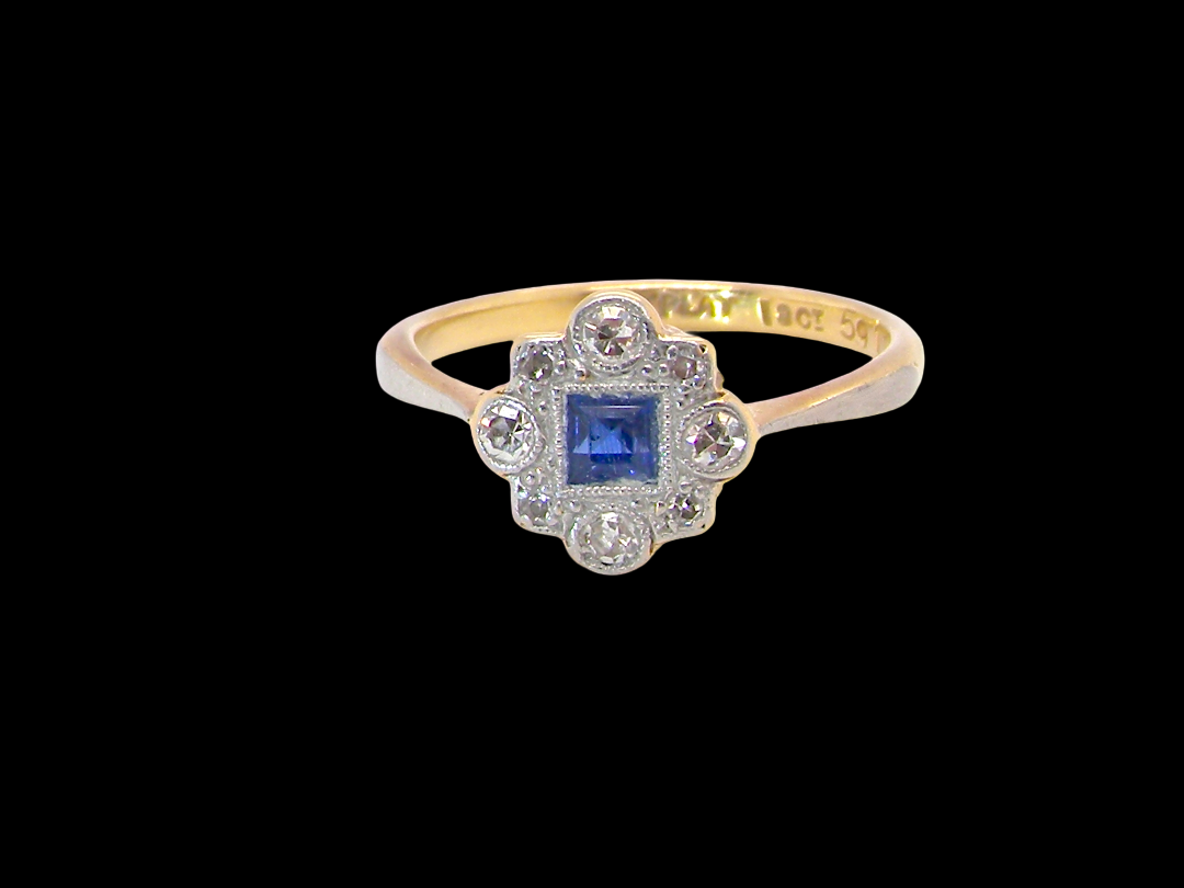 A pretty early 20th century cluster ring. The centre stone a square mid blue sapphire, mille grain setting.&nbsp;