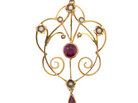 A pretty early 20th century pendant. Openwork design with a round garnet to the centre, measures 5.6mm, 