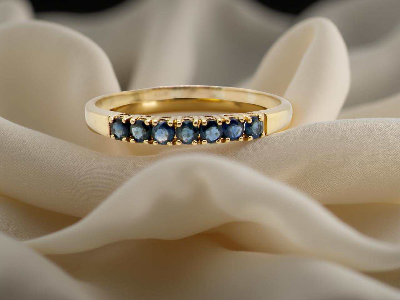 A sapphire half hoop eternity ring 