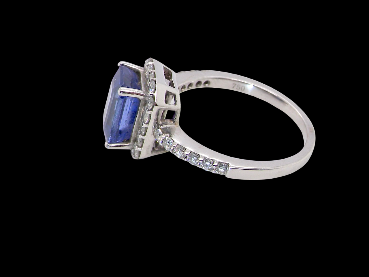 side  cluster ring featuring a 4A quality Tanzanite as its centre stone. A