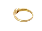 A polished yellow gold ring with a unique, organic curved shape and a circular cutout detail on the top, shown against a plain white background.