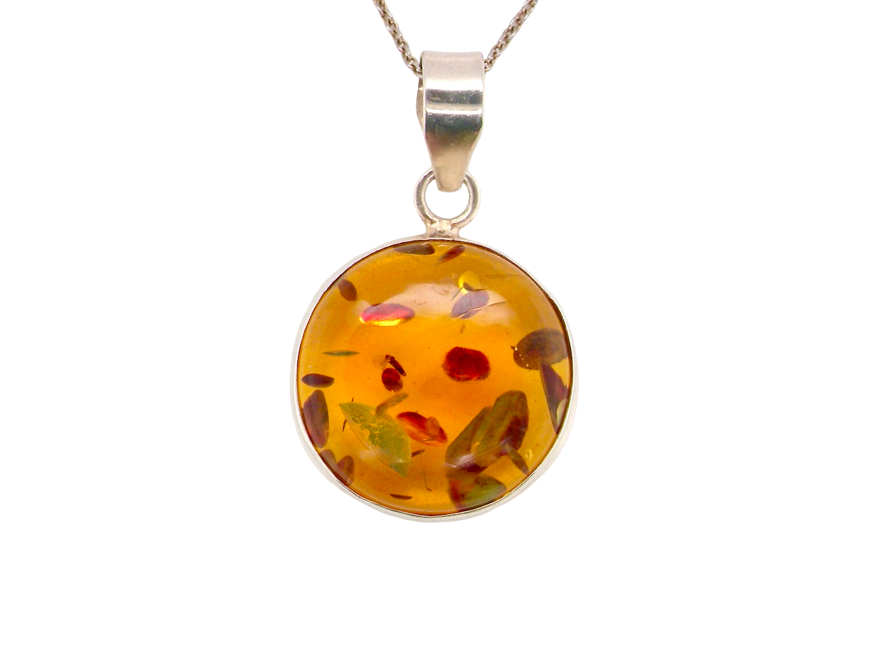 A sterling silver pendant. Features a large circular amber stone, diameter 25mm