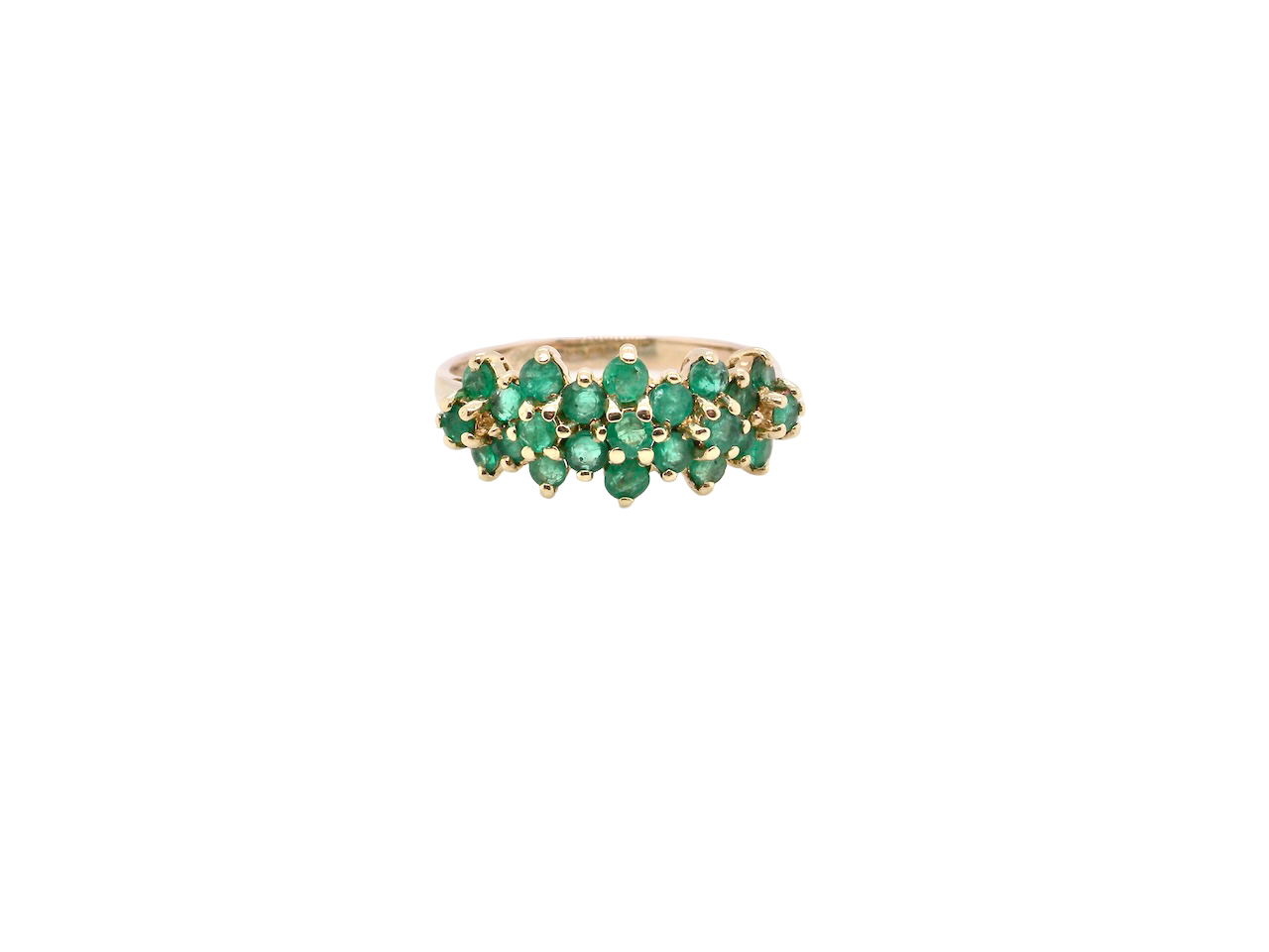 A striking and unusual dress ring, designed with multiple clusters of round-cut emeralds set beautifully across the finger for a bold, eye-catching look.