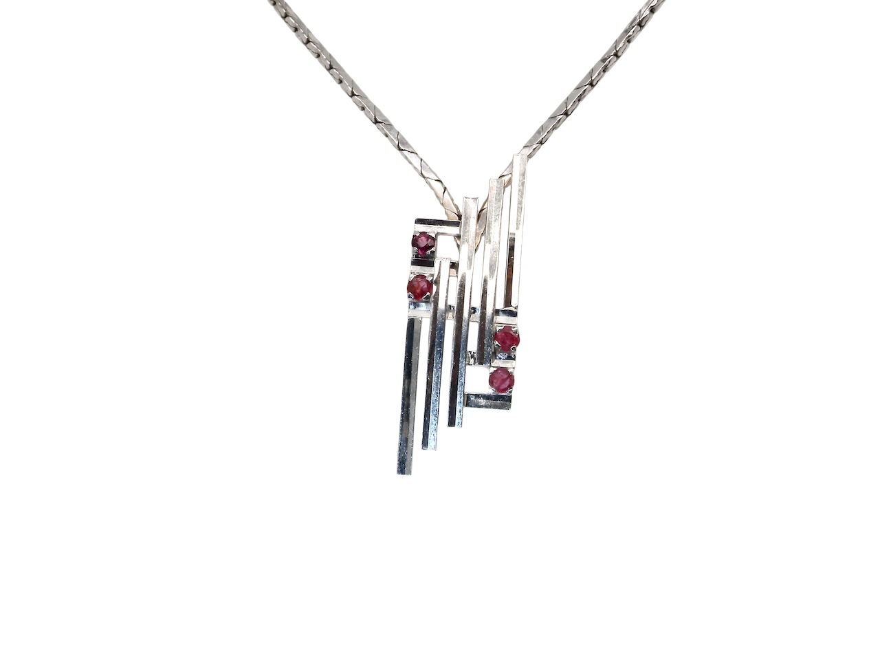 A striking modern pendant set with four 3mm rubies. The pendant measures 40mm x 14mm and features a sleek design of five horizontal bars, with the outer bars each set with vibrant round rubies.