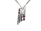 A striking modern pendant set with four 3mm rubies. The pendant measures approximately 40mm x 14mm and features a sleek design of horizontal bars, with the outer bars each set with vibrant round rubies.