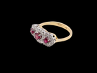 A striking&nbsp; triple cluster ring crafted in 18 carat gold, dating circa 1990–2000, and fully hallmarked in the UK.

✨ Design &amp; Gemstones

red rubies set to the centre of each cluster