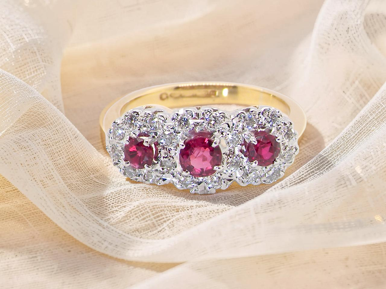 A striking&nbsp; triple cluster ring crafted in 18 carat gold, dating circa 1990–2000, and fully hallmarked in the UK.


