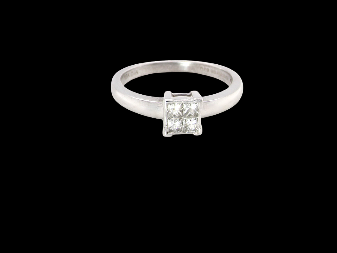 A stylish modern 18 carat white gold diamond cluster ring, with a beautifully clean and understated design.

The square-shaped head is set with four Princess cut diamonds,