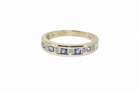 A tanzanite and diamond half eternity ring