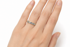 Tanzanite eternity ring on a hand