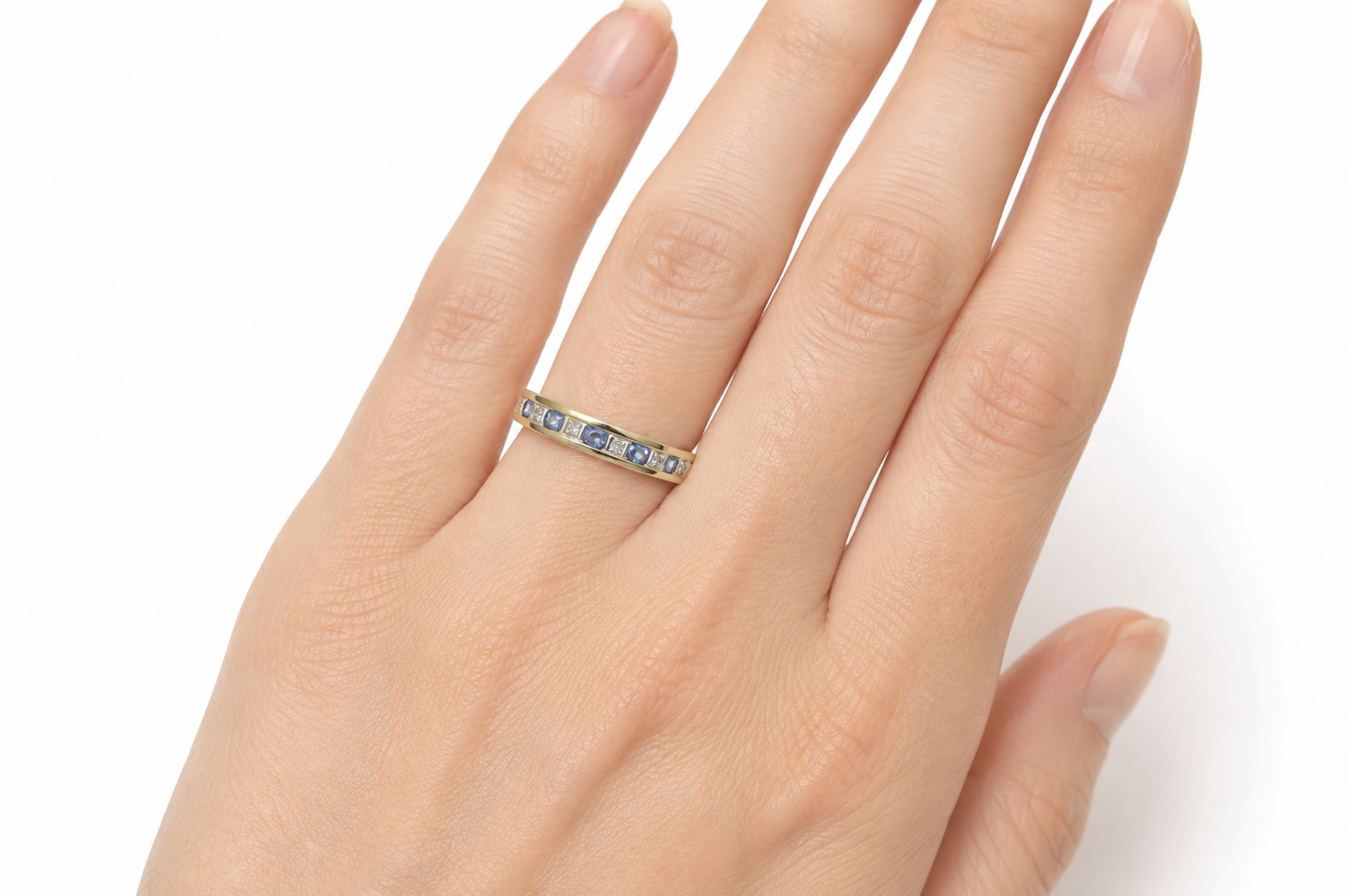 Tanzanite eternity ring on a hand