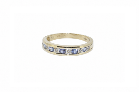 A 9ct gold tanzanite and diamond half eternity ring