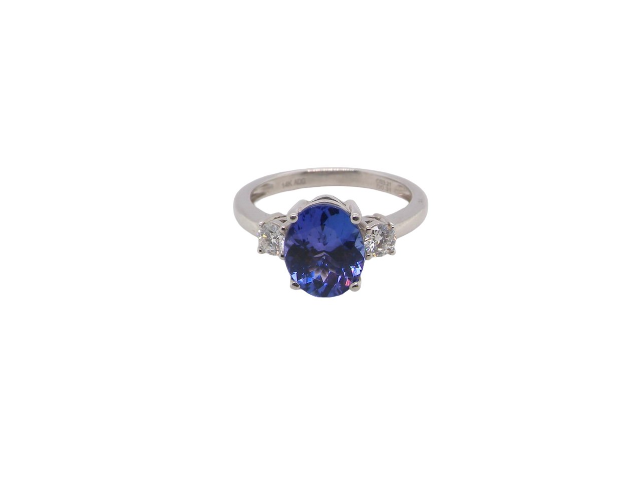 A three stone ring that features an impressive tanzanite centre stone that measures 10x8mm (3.21 carats confirmed) AAA colour.&nbsp;