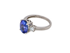 A three stone ring that features an impressive tanzanite centre stone that measures 10x8mm (3.21 carats confirmed) AAA colour.&nbsp;side