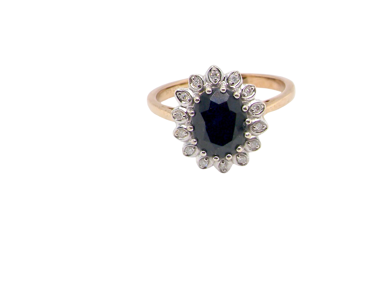 A timeless cluster ring featuring a deep ink-black blue sapphire 