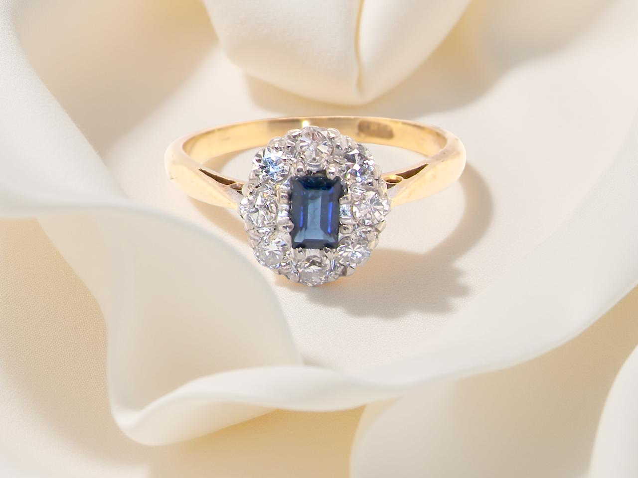 A traditional 1970s cluster ring featuring a&nbsp;rectangular-cut sapphire, A