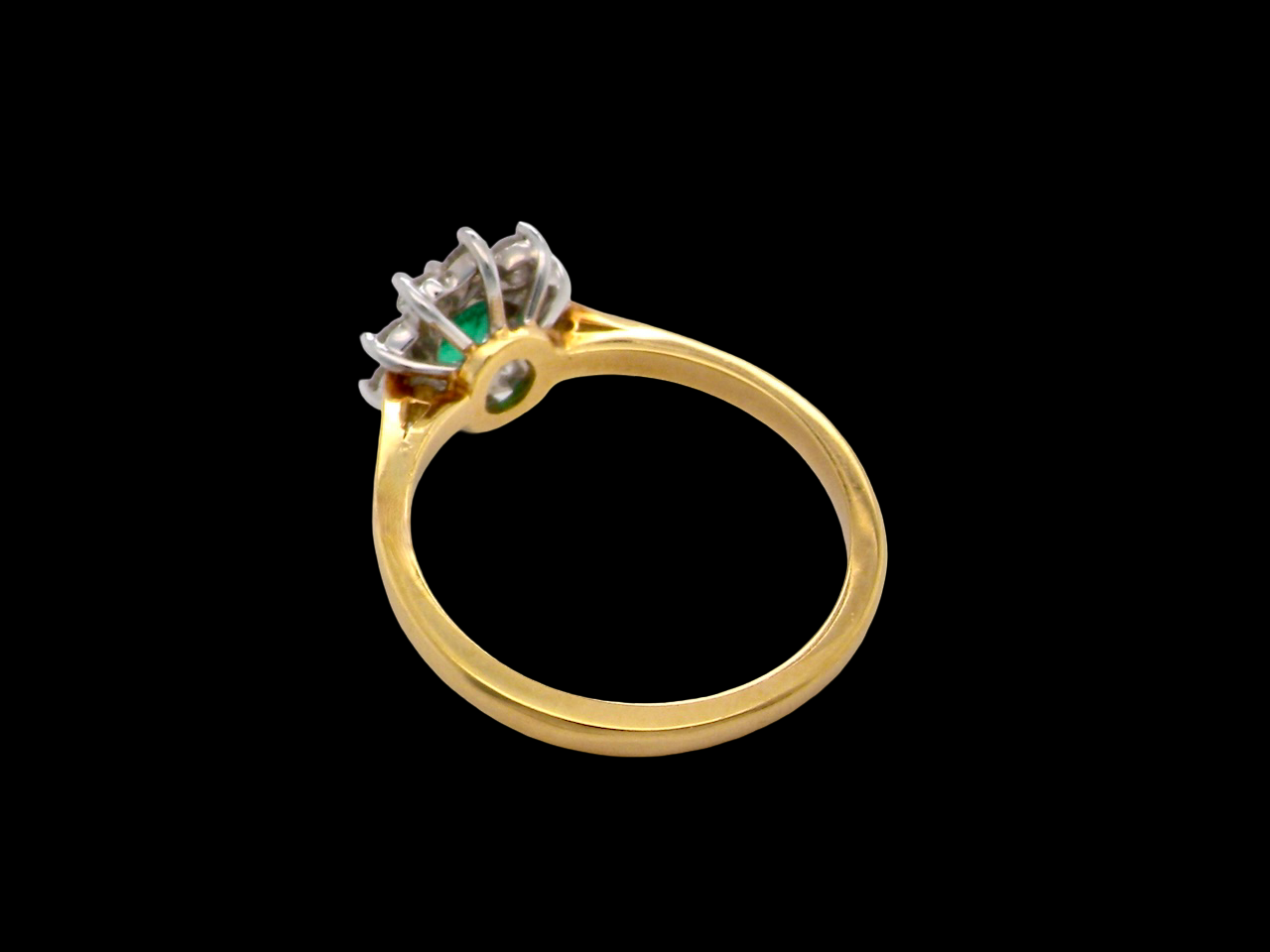 A traditional Emerald and Diamond cluster ring
