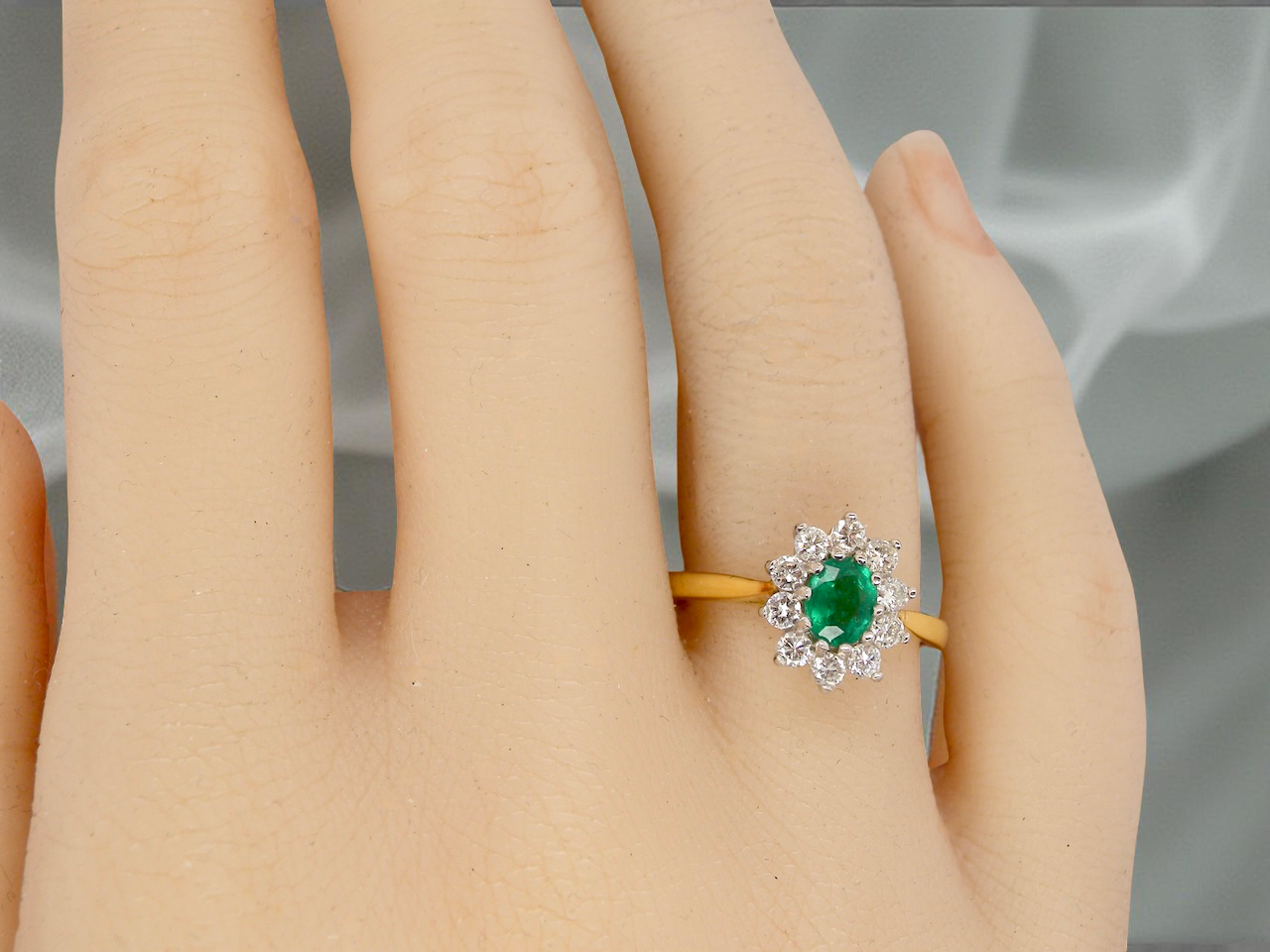 A traditional Emerald and Diamond cluster ring