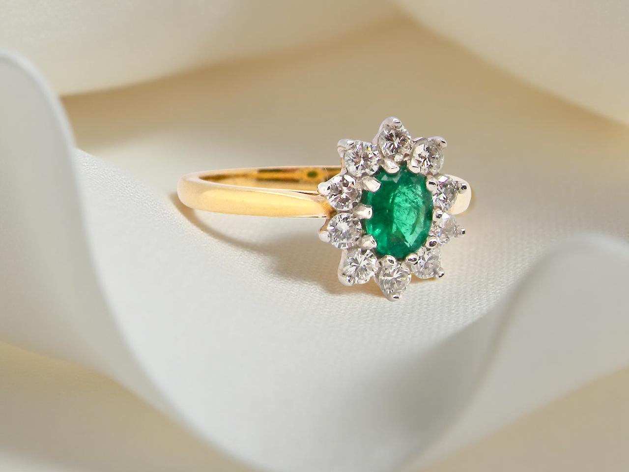 A traditional Emerald and Diamond cluster ring