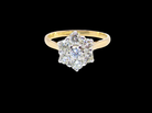 A traditional cluster ring. Features to the centre a 3.4mm brilliant cut white diamond (est 0.15 carats)

Surrounded by  3.4mm diamonds to match