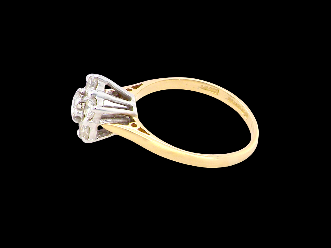 A traditional cluster ring. Features to the centre a 3.4mm brilliant cut white diamond (est 0.15 carats)

Surrounded by six 3.4mm diamonds to match side