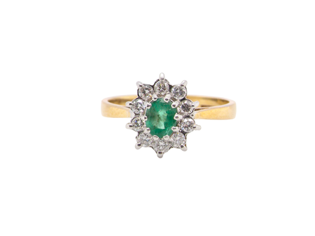 A traditional Emerald and Diamond cluster ring