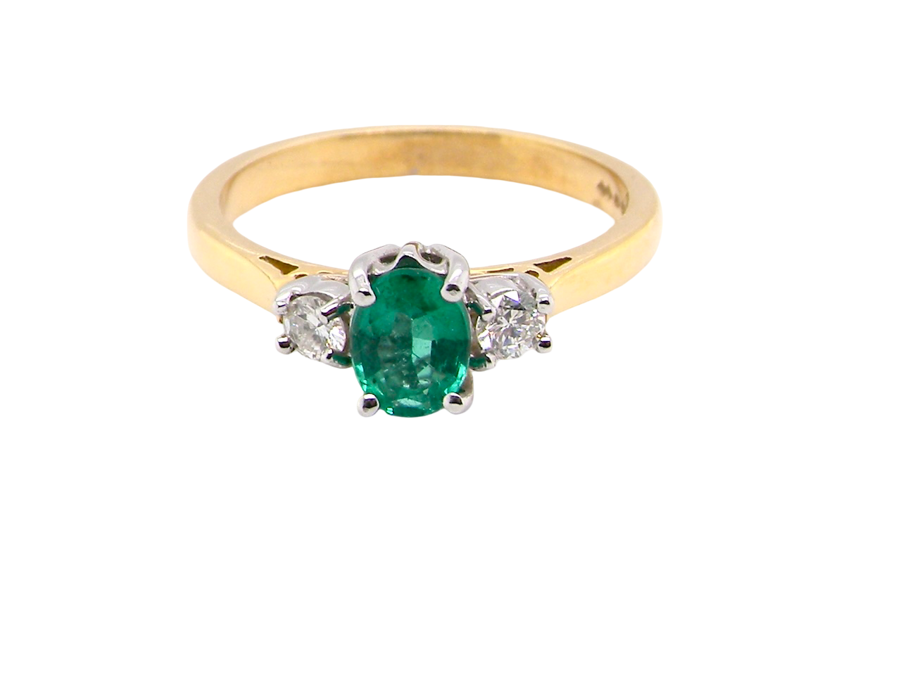 A traditional three stone Emerald and Diamond ring