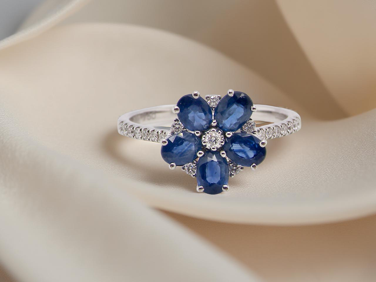 A very pretty cluster ring. Features cornflower blue oval cut sapphires
