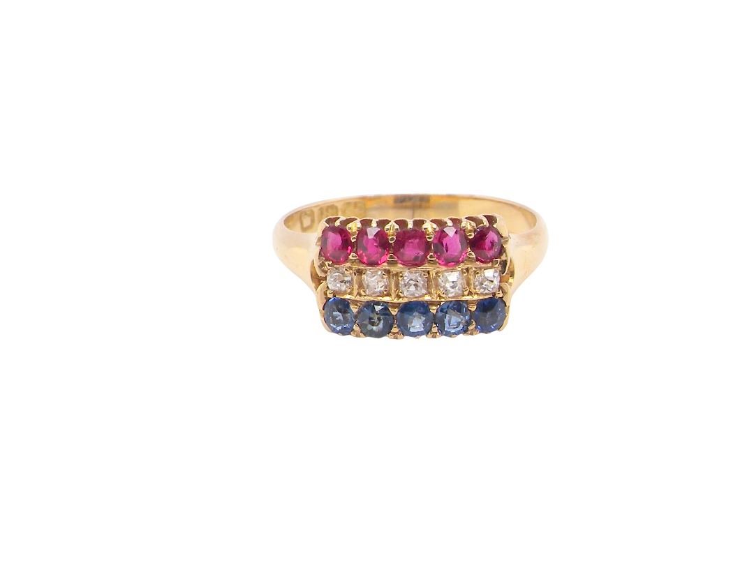 A yellow gold ring featuring three rows of round gemstones: a top row of pink stones, a middle row of clear stones, and a bottom row of blue stones, set against a plain white background.