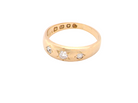 A vintage 18 carat gold three stone ring. Set with brilliant cut white diamonds, cente 3mm, each side a 2.4mm diamond (total est 0.20 carats) Colour I-j, clarity Si.&nbsp;
