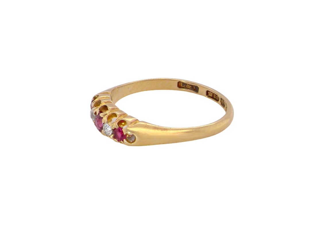A vintage 18 carat gold three stone ring. Set with brilliant cut white diamonds, cente 3mm, each side a 2.4mm diamond (total est 0.20 carats) Colour I-j, clarity Si.&nbsp;
side