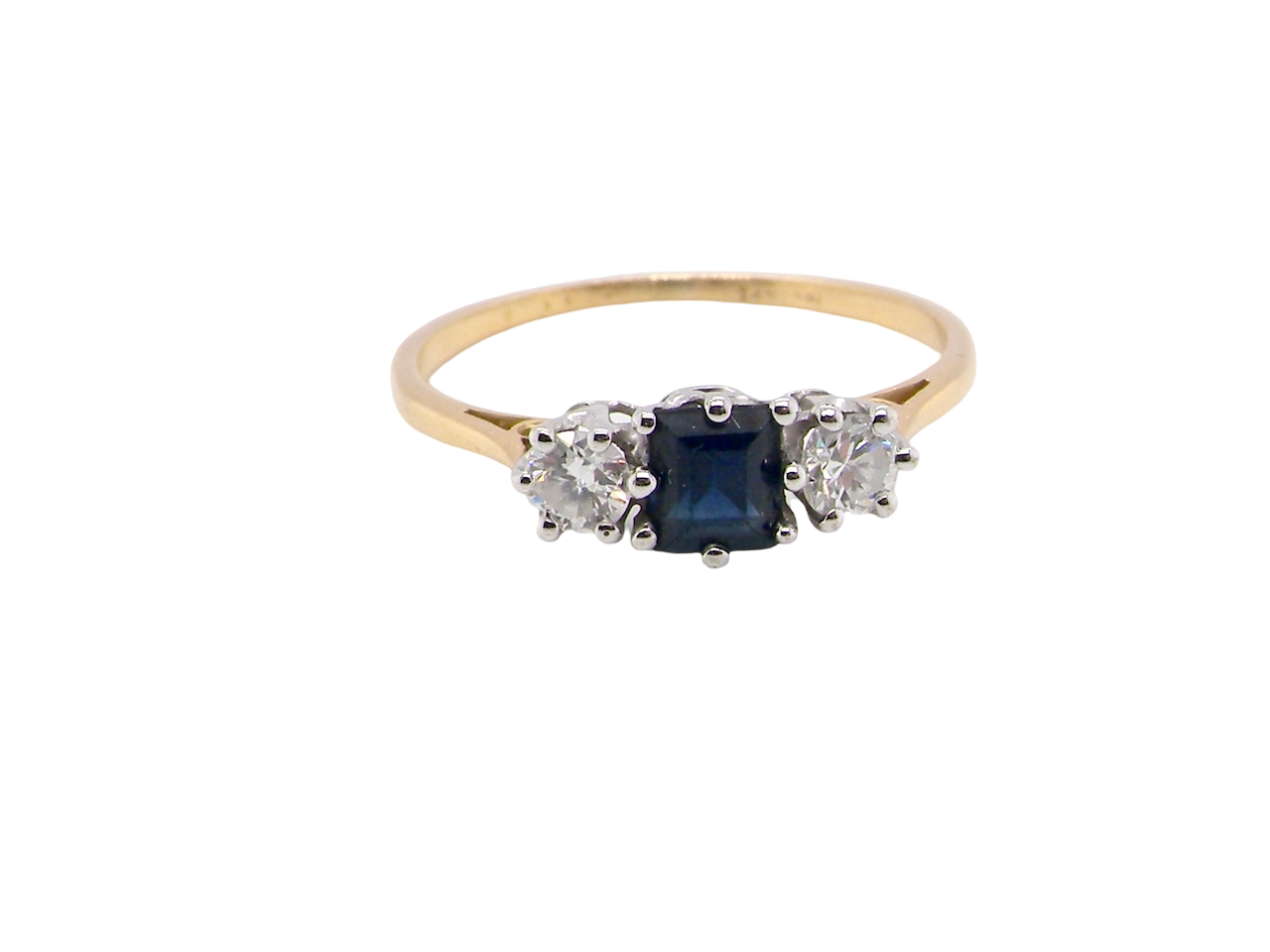 A vintage 1950s three stone ring. Centre stone an ink black blue sapphire, measures 4x4mm (est 0.30 carats).
