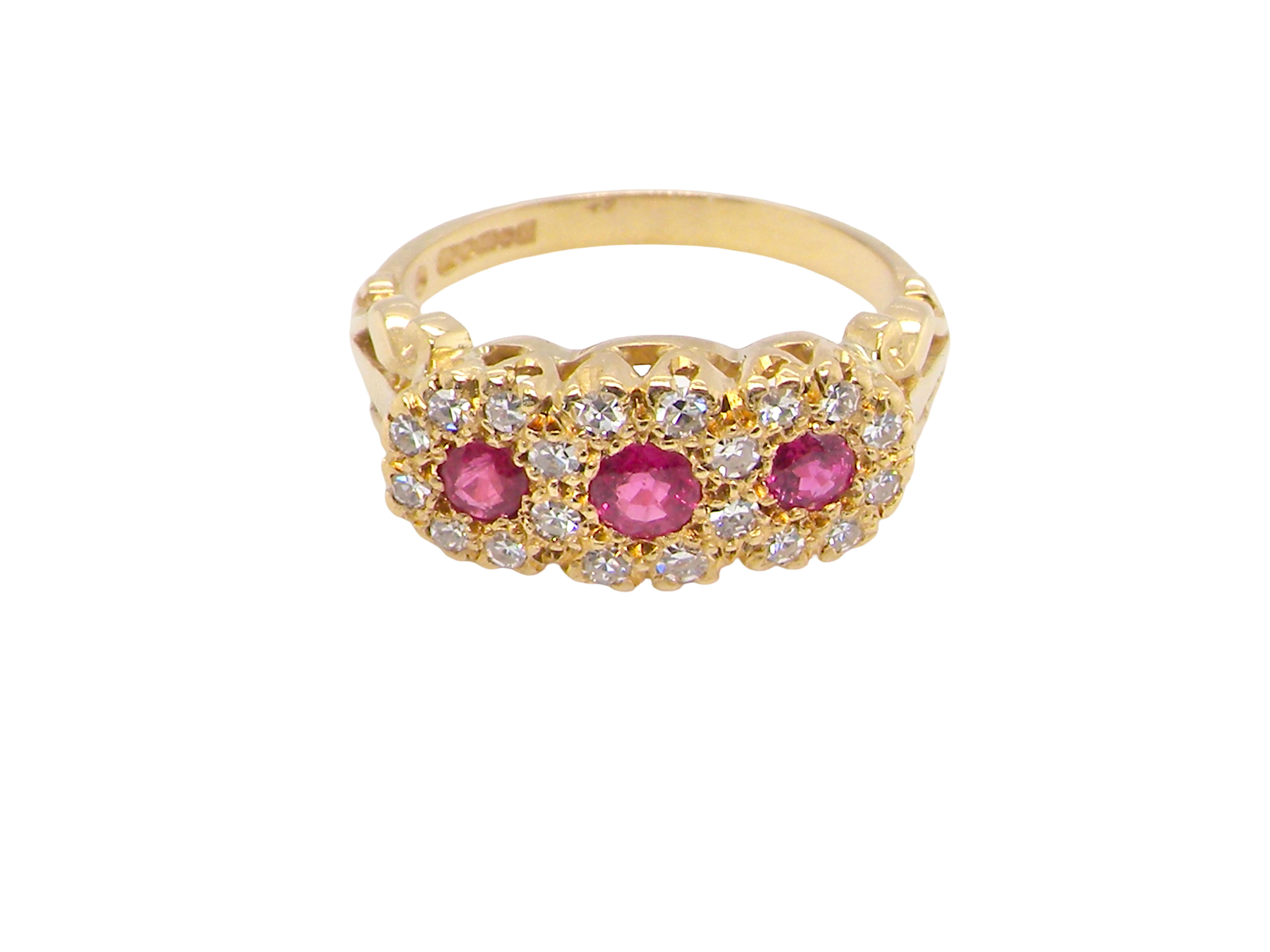 Gold ring with pink gemstones and diamonds on a white background