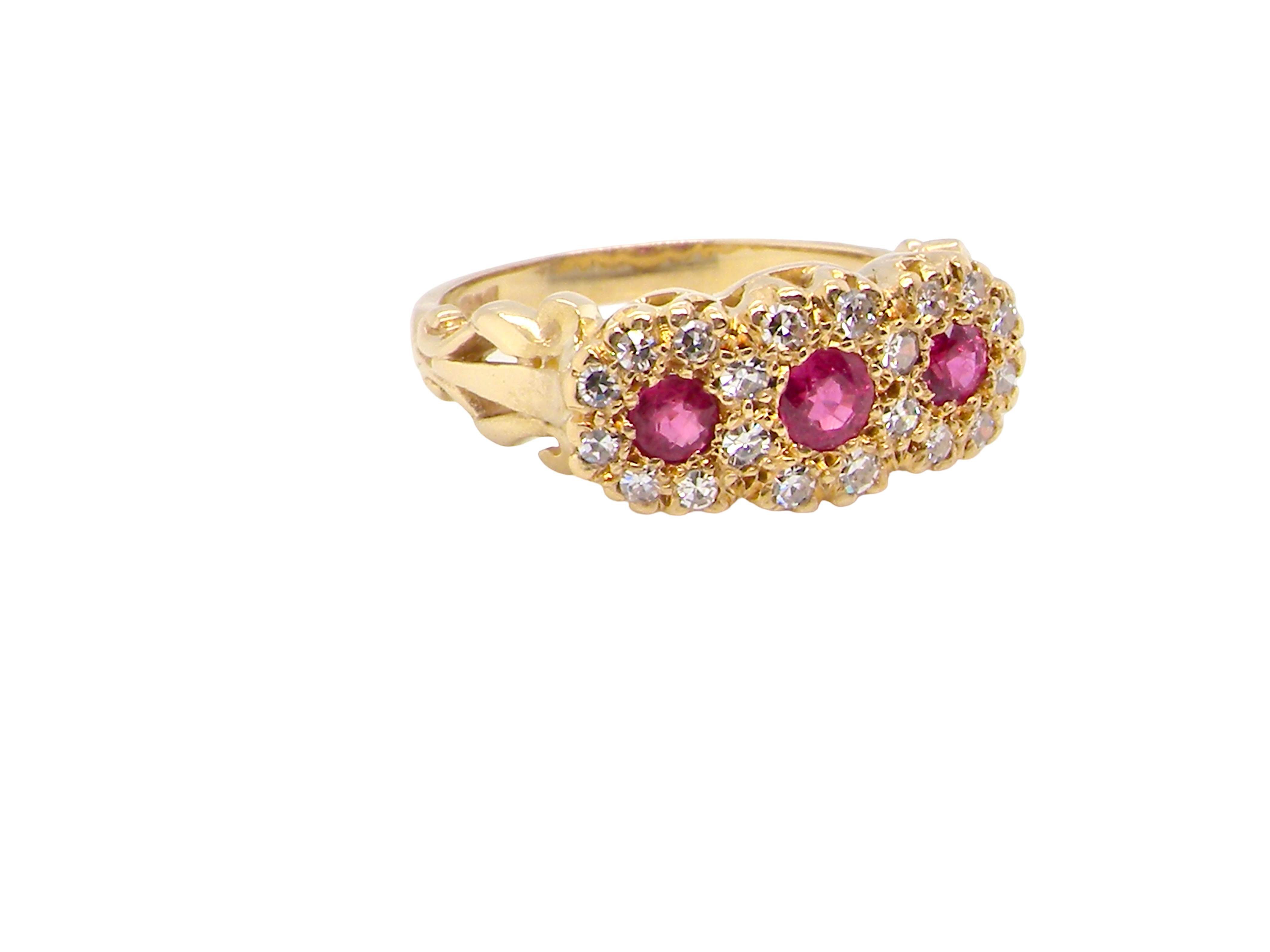 Gold ring with pink gemstones on a white background