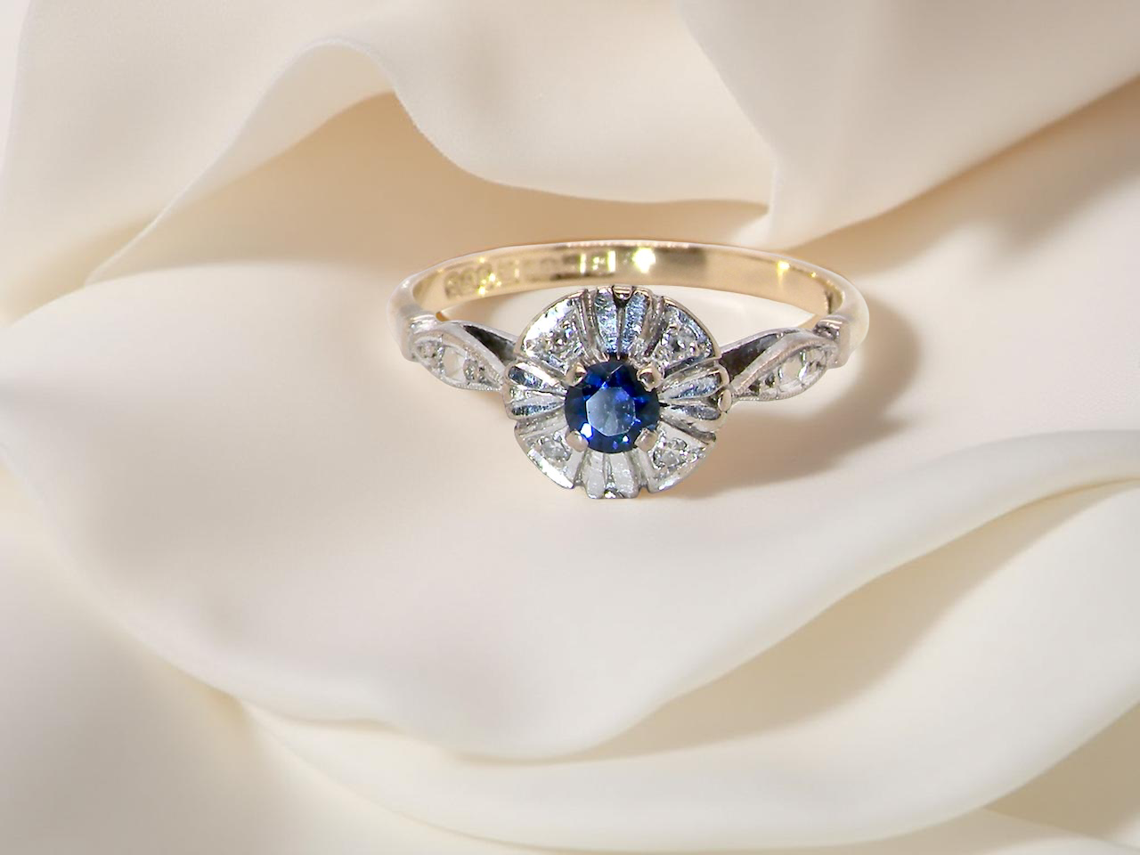 A vintage cluster ring featuring a deep&nbsp;black-blue sapphire  A