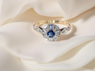 A vintage cluster ring featuring a deep&nbsp;black-blue sapphire  A