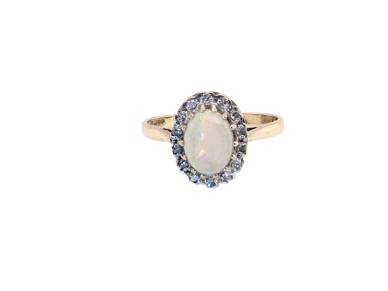 A vintage cluster ring set with an oval cabouchon cut opa