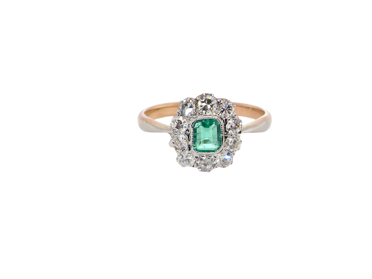 A vintage cluster ring, the centre stone a cushion shaped emerald 4x3.5mm, mid to dark green colour. Mille grain setting.
